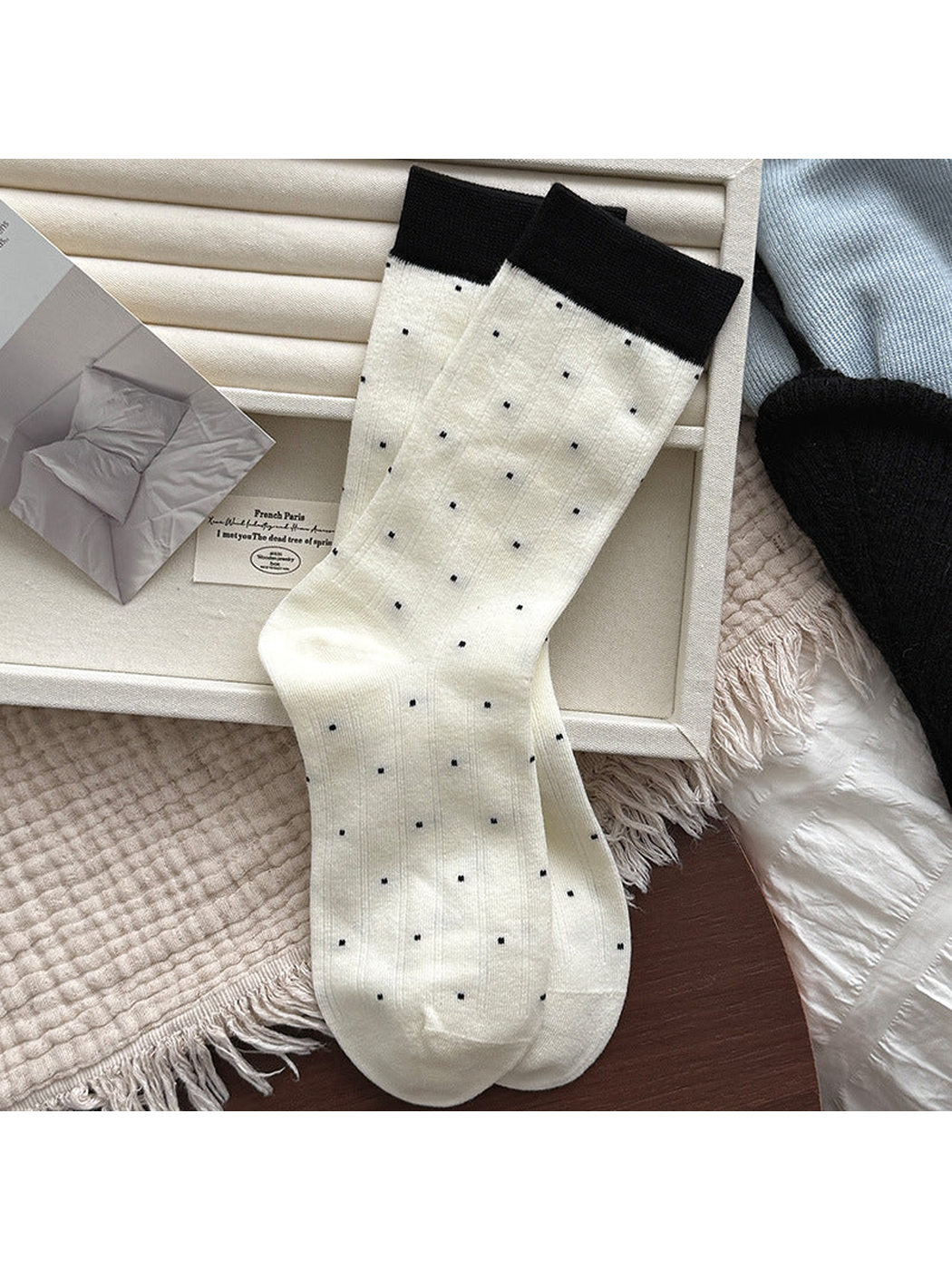 Ivory ribbed crew socks with small polka dots and black cuffs