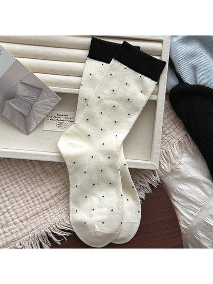 Ivory ribbed crew socks with small polka dots and black cuffs