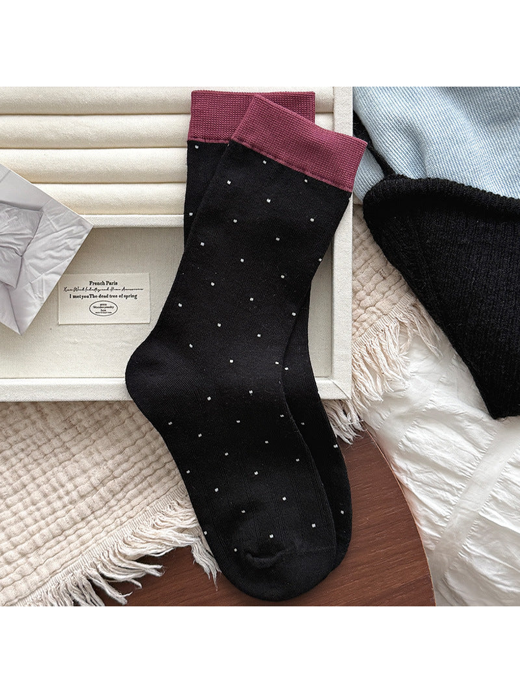 Black ribbed crew socks with small polka dots and burgundy cuffs