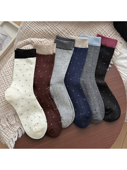 Six colors of ribbed polka-dot crew socks arranged on a tabletop