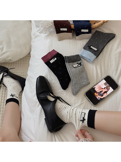 Polka-dot crew socks styled with black shoes alongside several color options