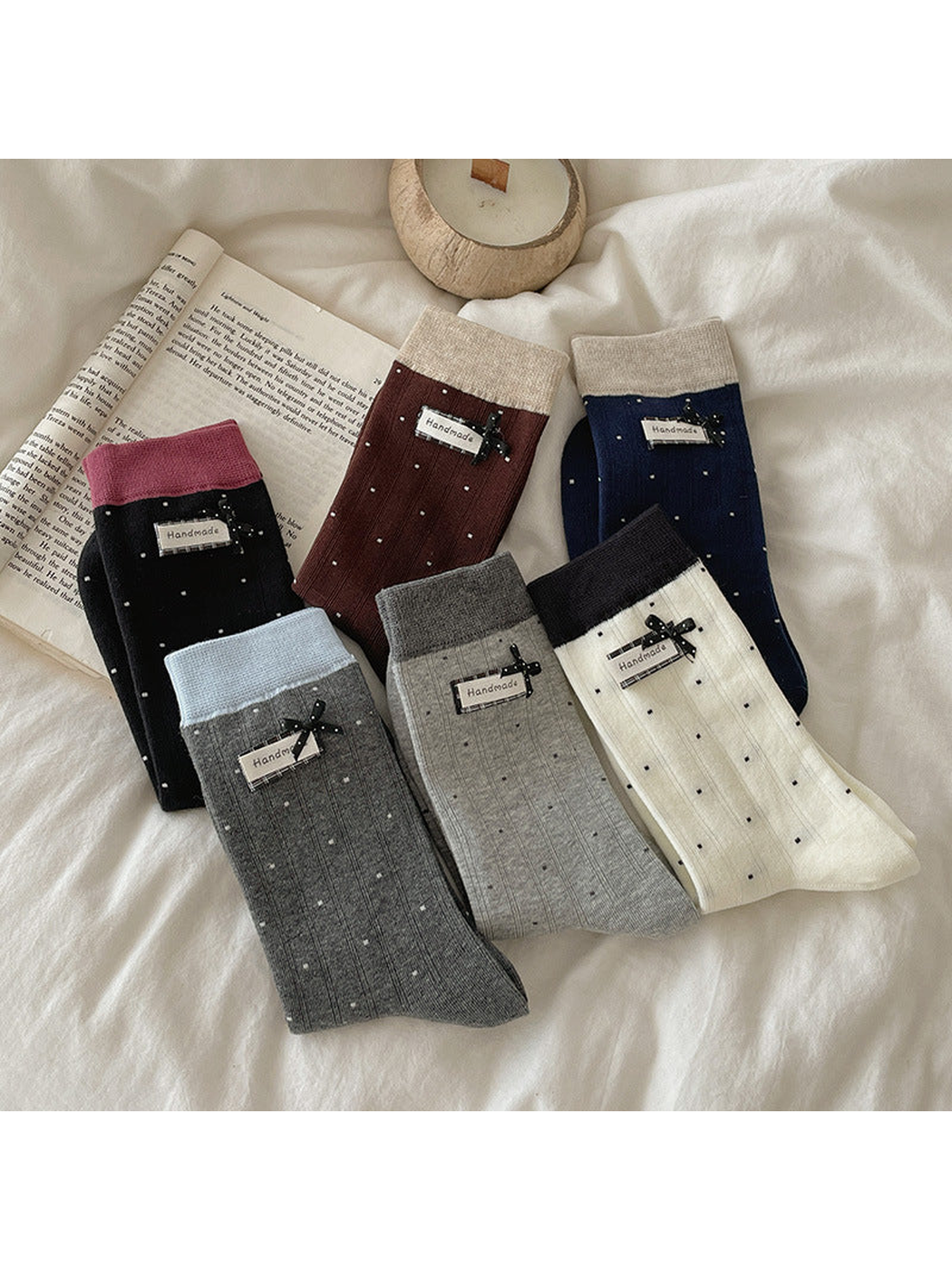Six polka-dot crew sock colors arranged on white bedding