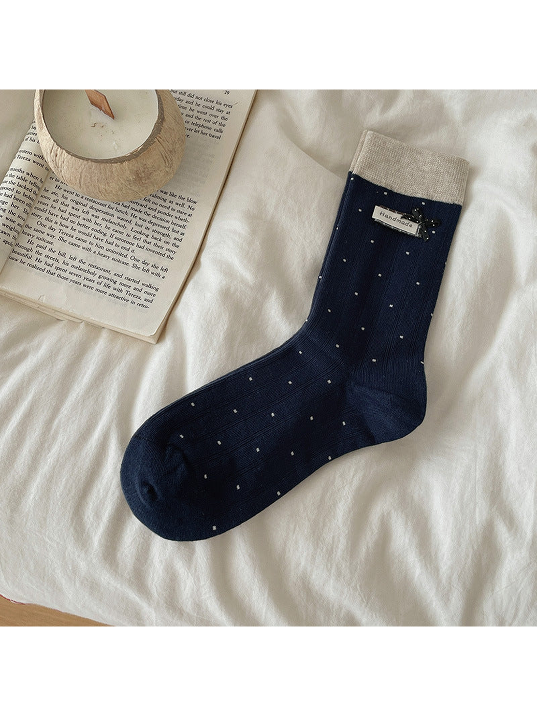 Navy polka-dot crew sock with contrasting cuff and bow accent