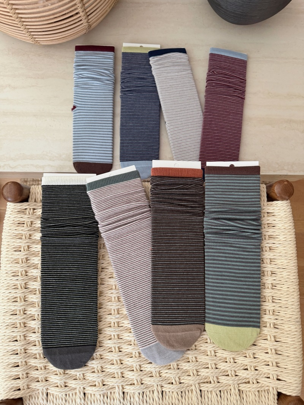 Eight colors of fine-striped crew socks displayed together