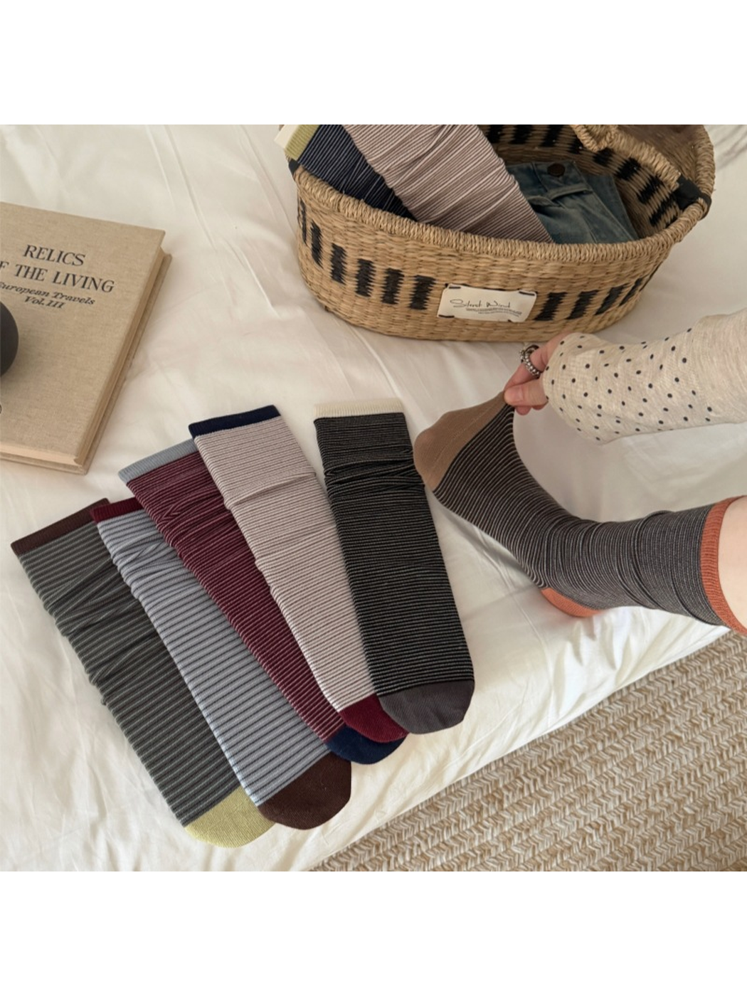 Orange striped crew sock flexed at the heel beside multiple color options