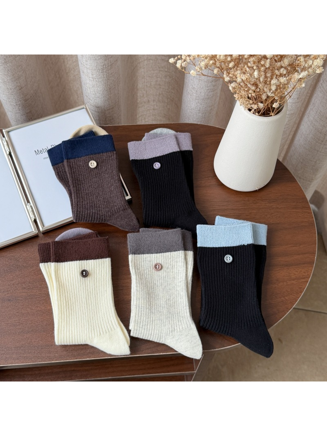 Five color-block ribbed crew sock styles arranged on a table