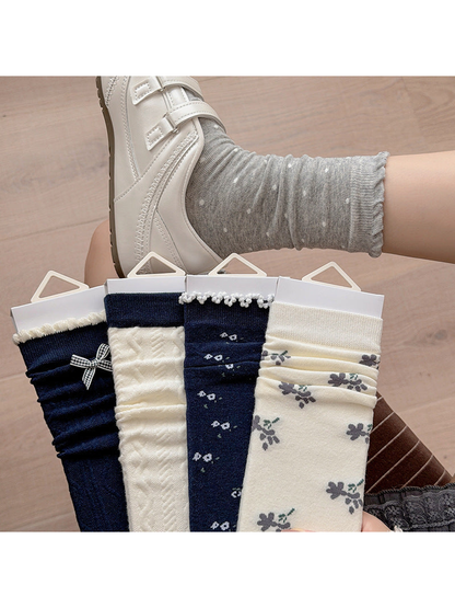 Cable, floral, polka dot and bow crew sock styles displayed together
