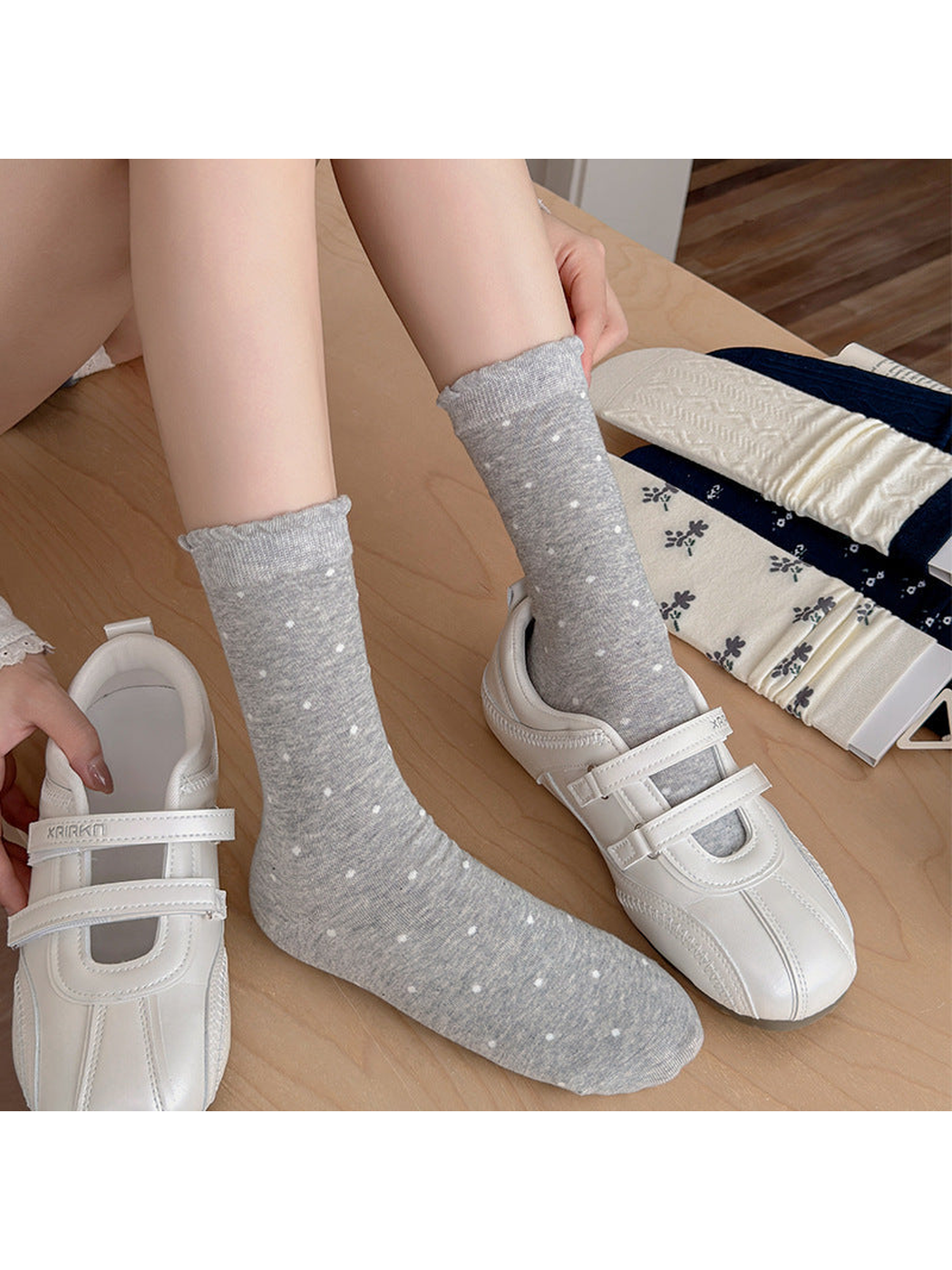 Heather gray polka dot crew socks styled with white shoes