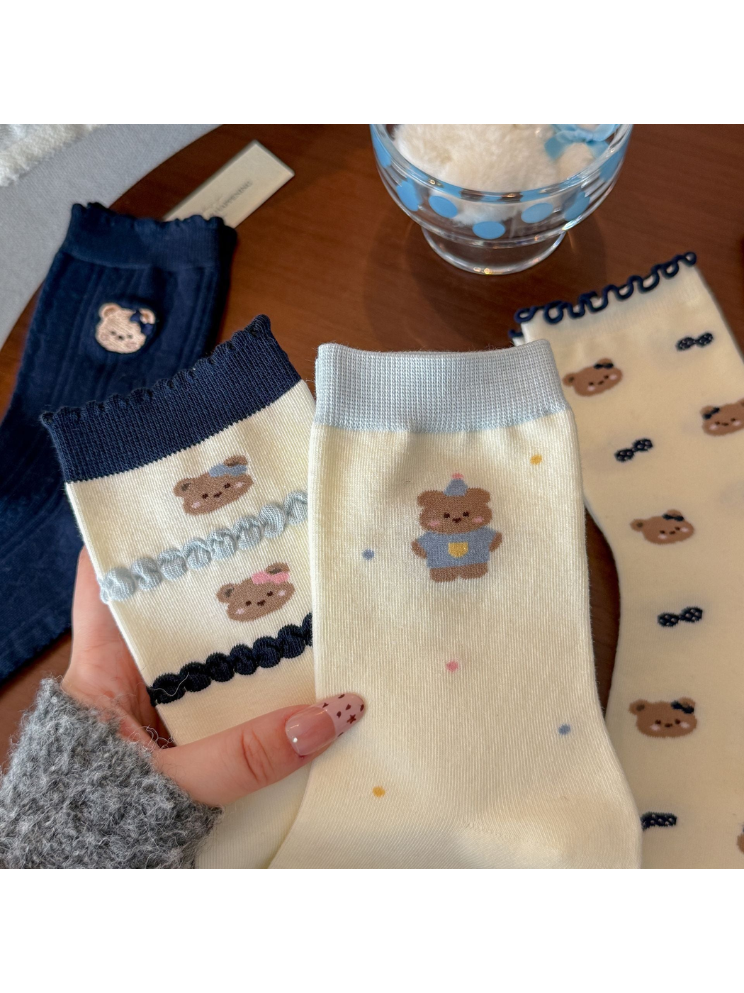 Close view of assorted bear-pattern crew socks with navy, gray and ivory details