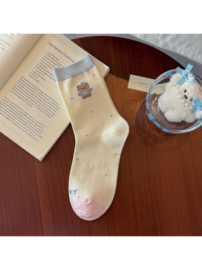Polka Dots crew sock in ivory with a dressed bear motif and colorful dots
