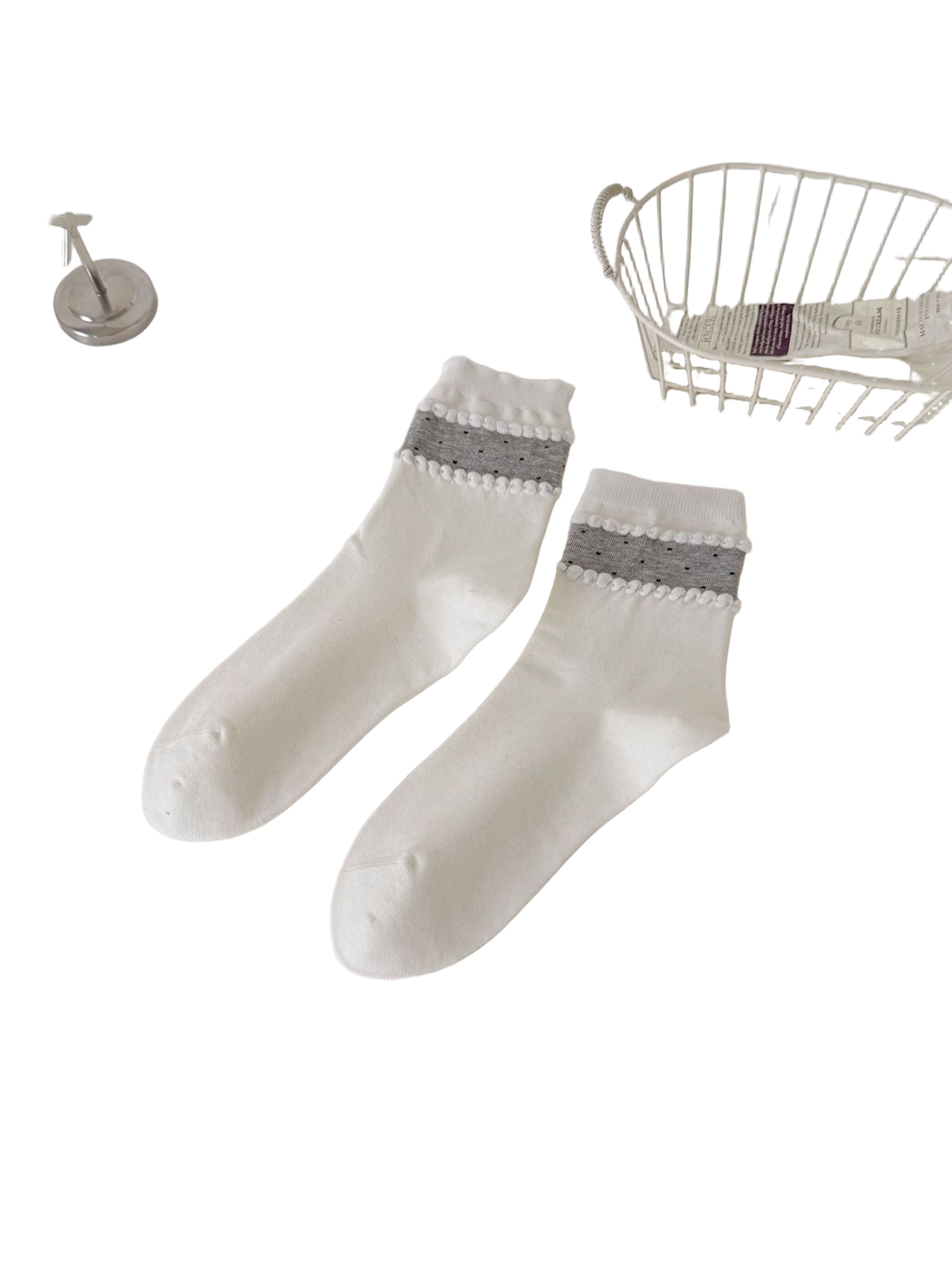 White crew socks with a gray dotted ankle band and raised trim