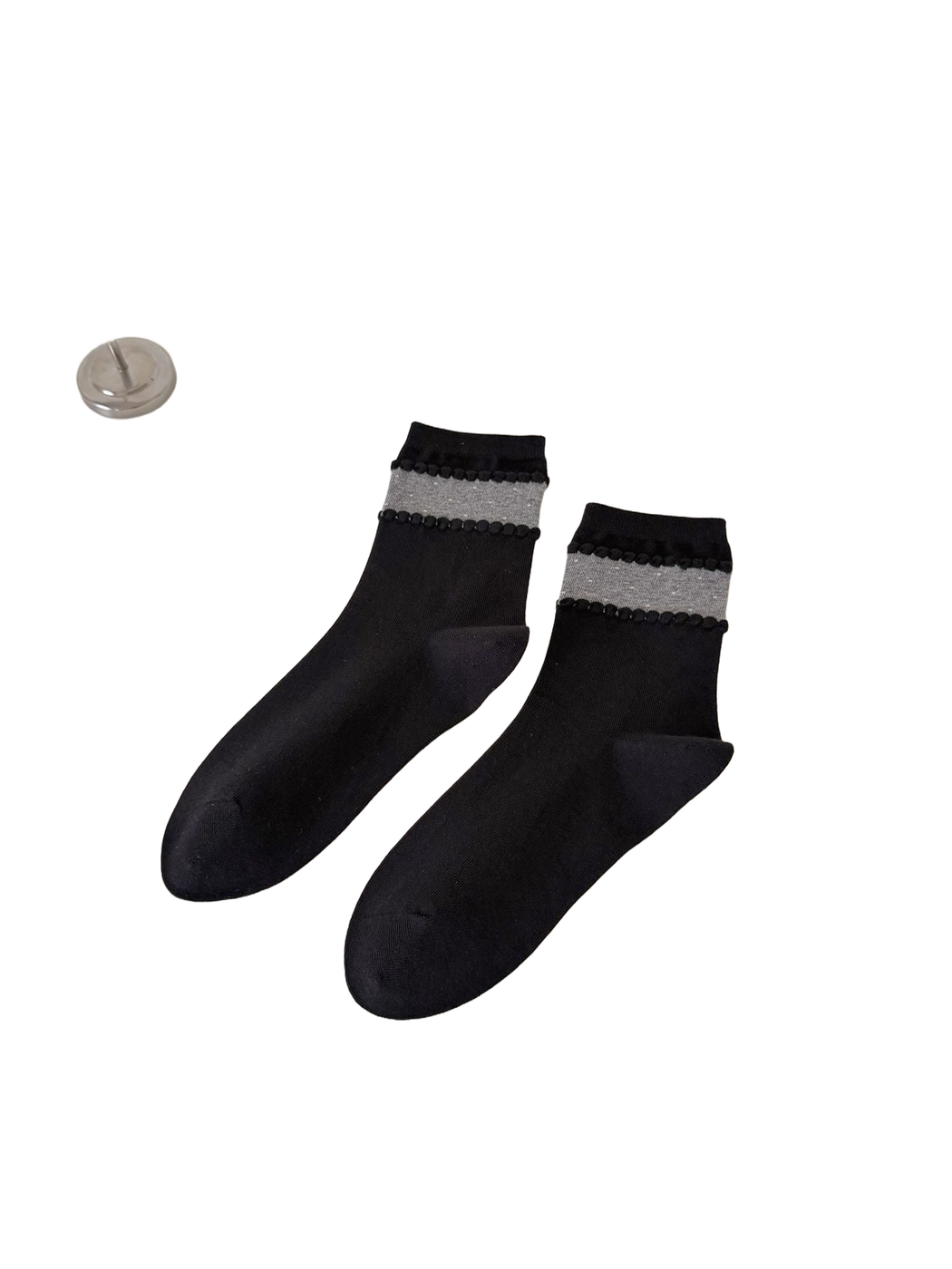 Black crew socks with a gray dotted ankle band and raised trim
