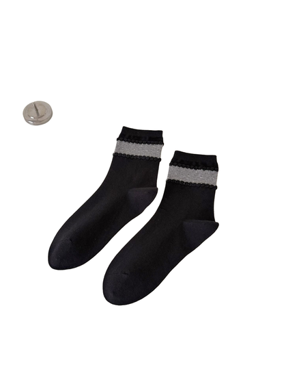 Black crew socks with a gray dotted ankle band and raised trim