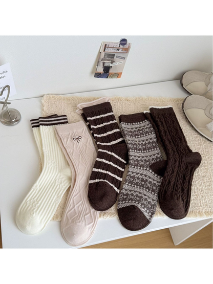 Five crew sock styles in ivory, blush and brown displayed together