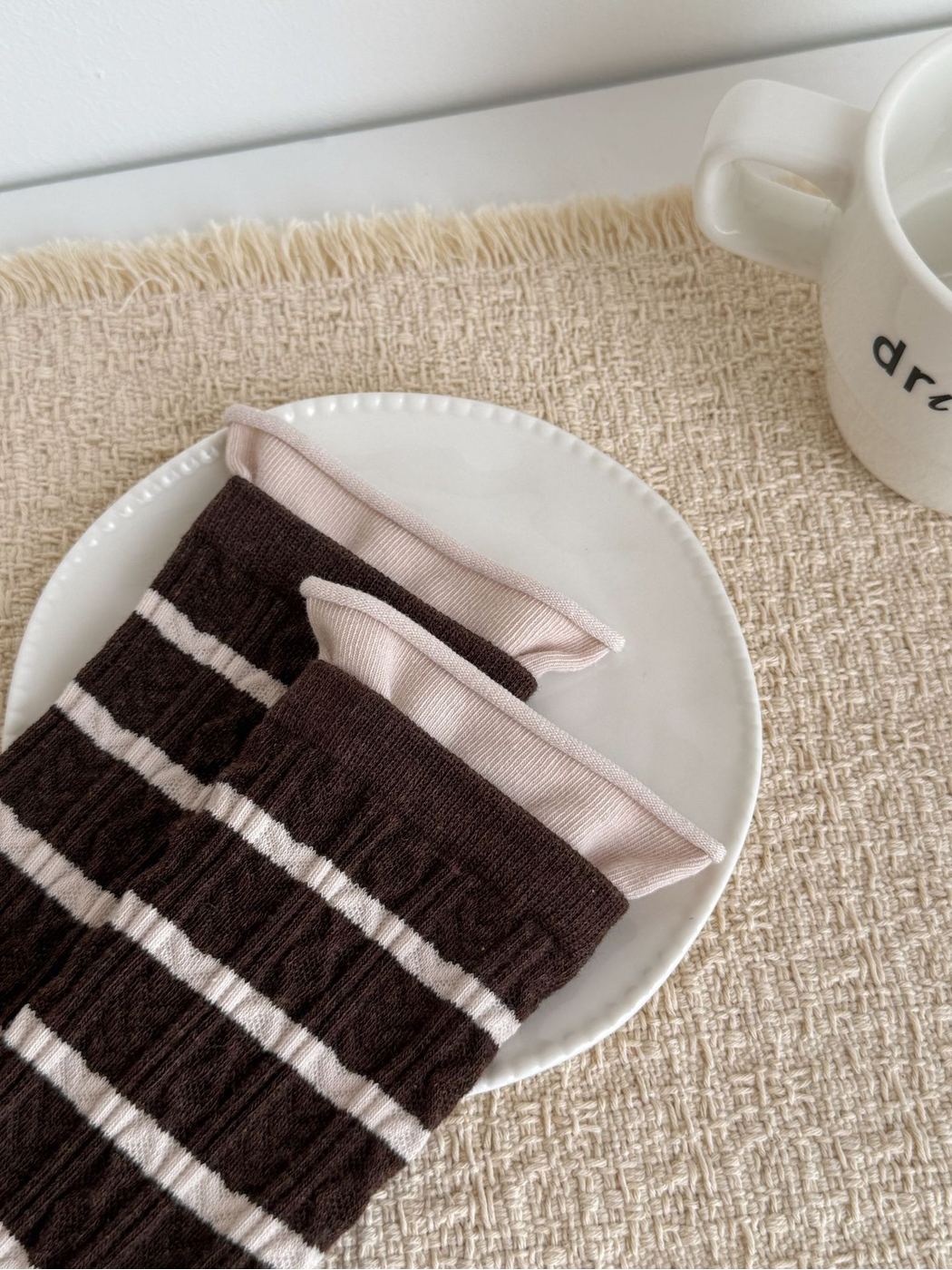 Close-up of striped socks with textured channels and contrasting cuffs