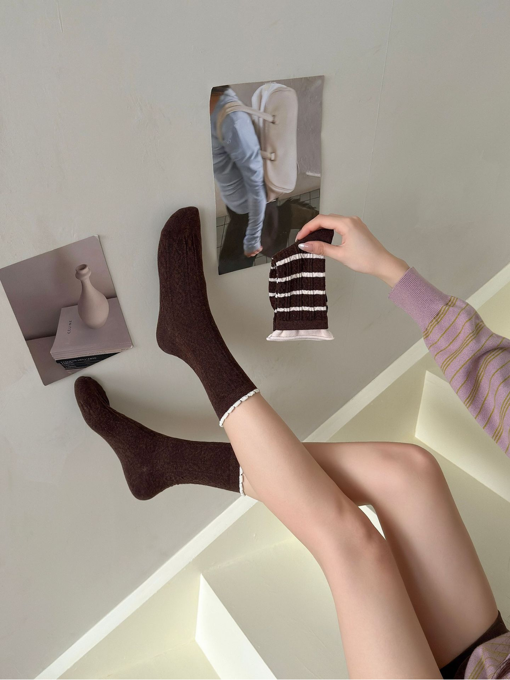 Brown cable-textured crew socks worn with narrow ivory ruffled cuff edges