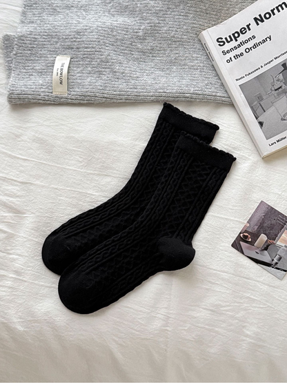 Cable style black crew socks with raised cable texture