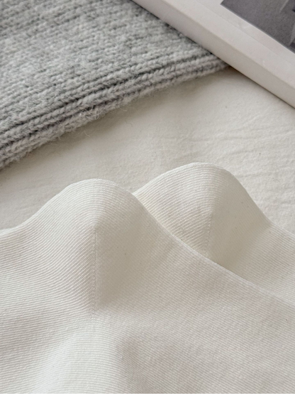 Close-up of the fine knit texture on ivory socks