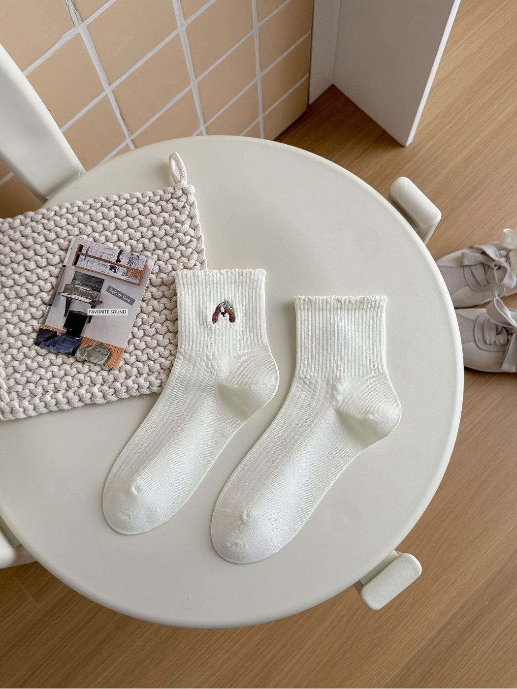 White ribbed crew socks with a small dog face motif