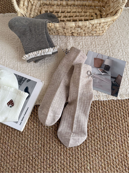 Beige bow socks displayed from front and back with Gray and Ivory styles