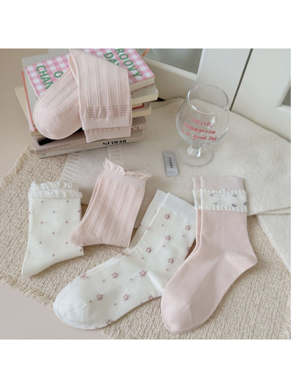 Five ivory and pink crew sock styles displayed together