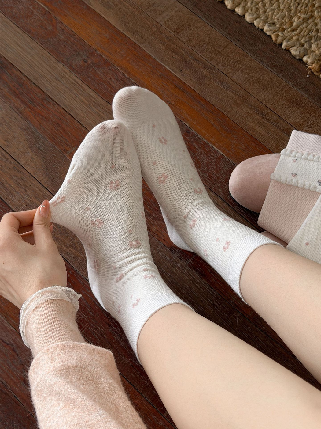 Close-up of the Ivory Floral socks and scattered small pink flower pattern
