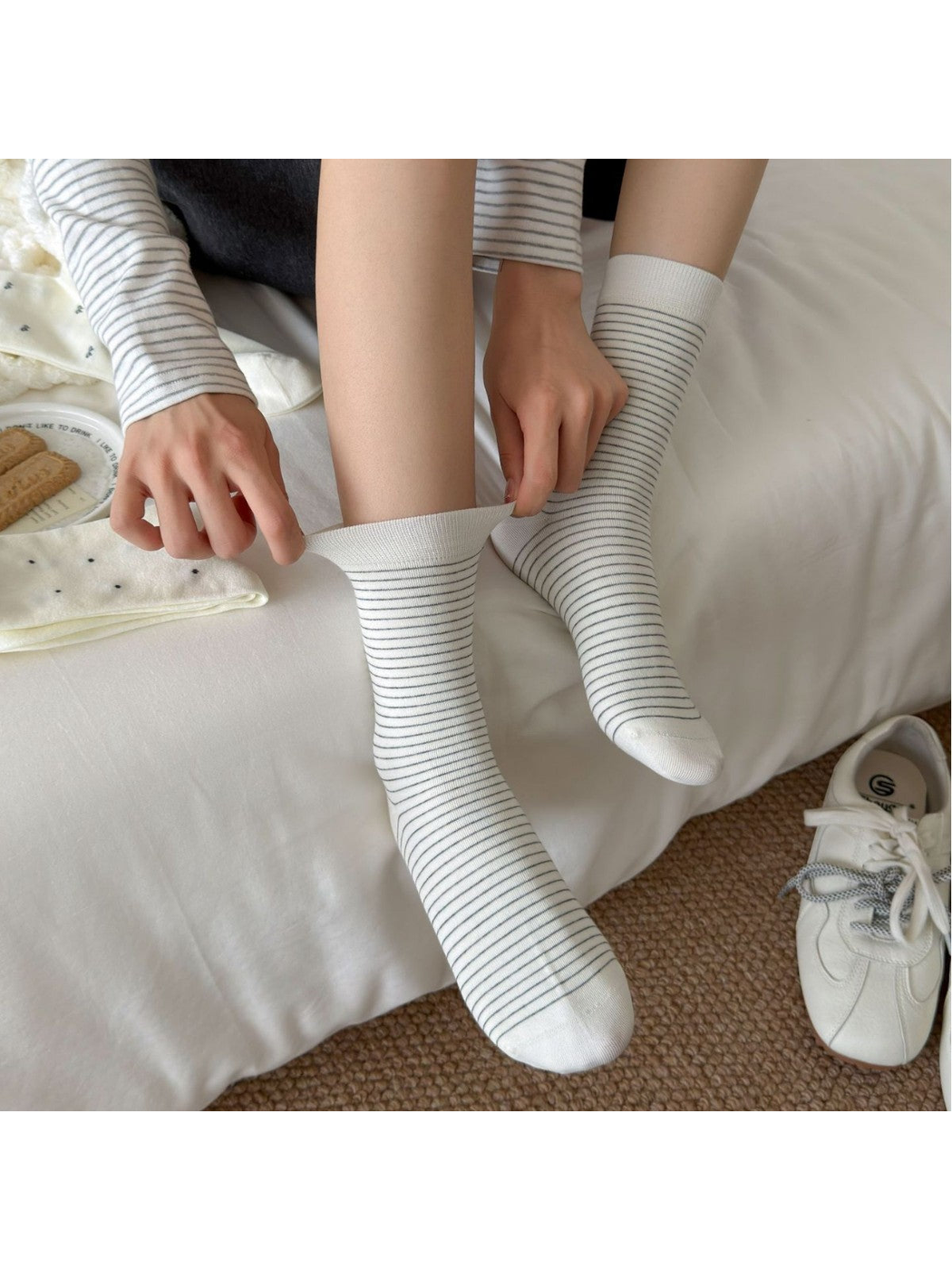Fine stripe crew socks with the cuff gently stretched to show their construction