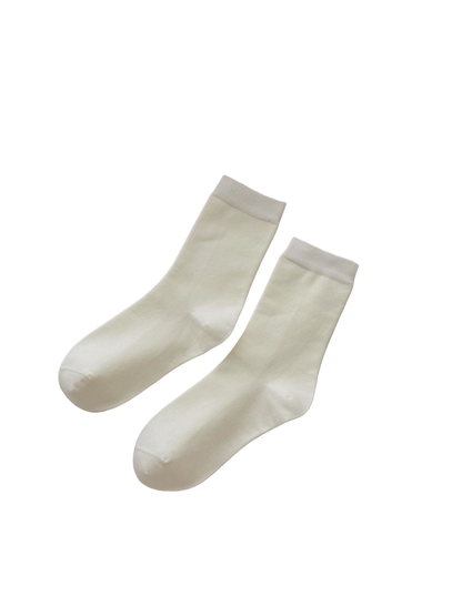 Solid ivory crew socks with ribbed cuffs and shaped heels