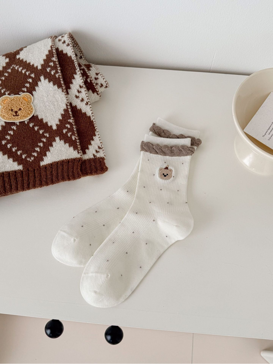 Ivory crew socks with brown ruffled cuffs and embroidered bear faces