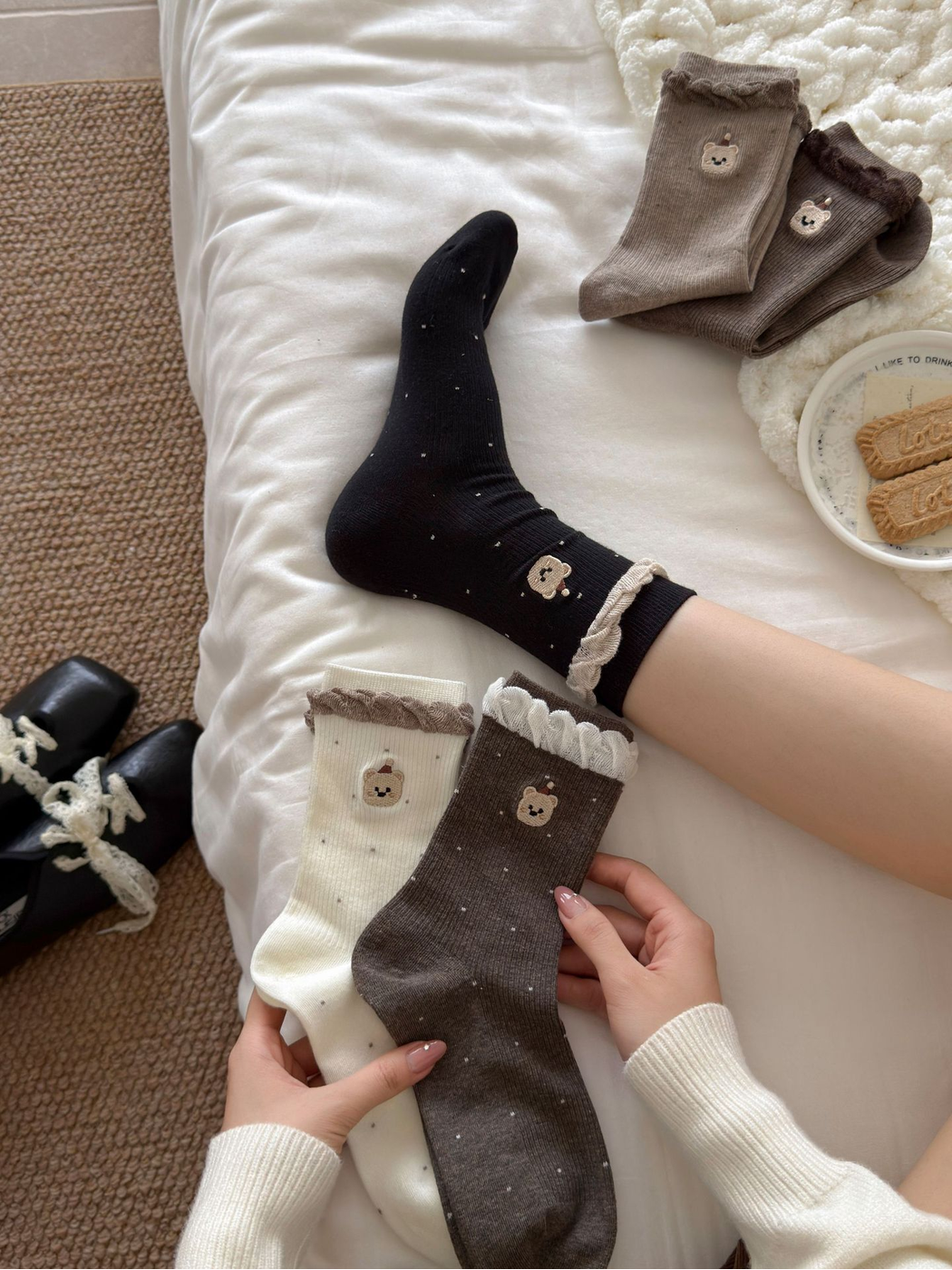 Black bear-motif crew socks worn beside Ivory and brown color variations