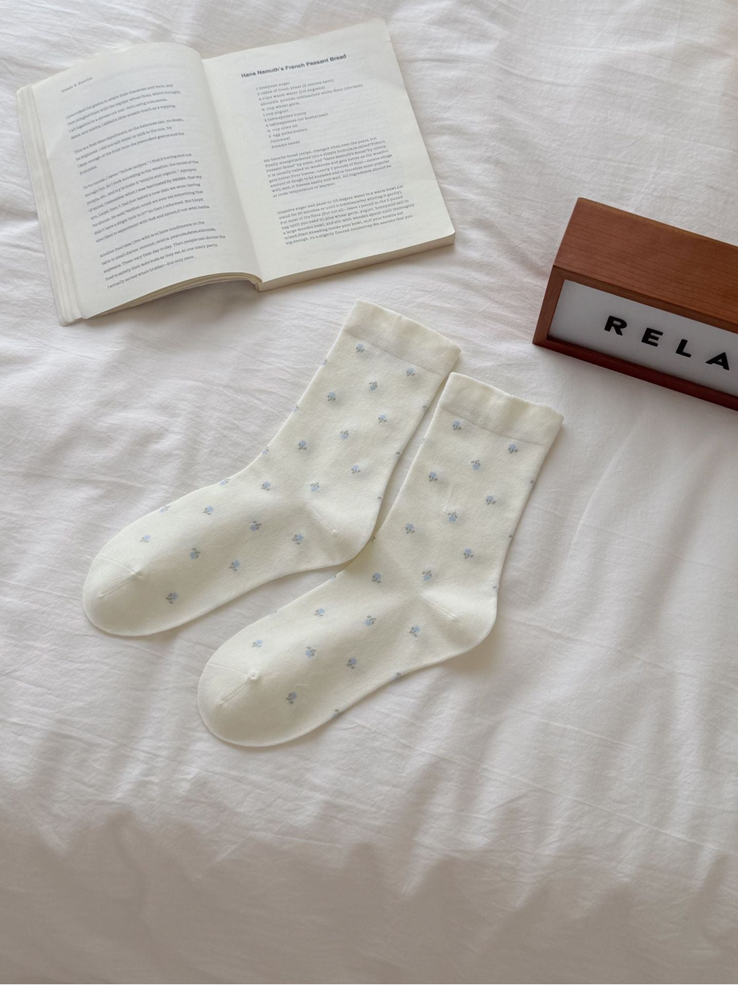 Ivory crew socks with scattered light blue floral sprigs