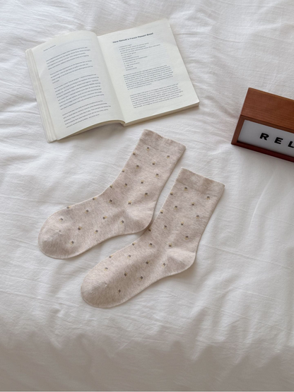 Beige crew socks with scattered yellow floral sprigs