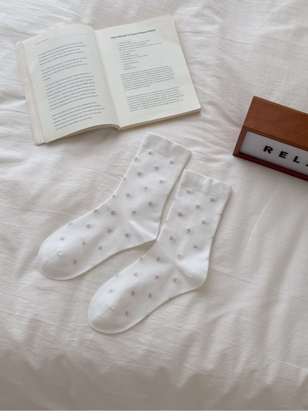 White crew socks with scattered pink floral sprigs