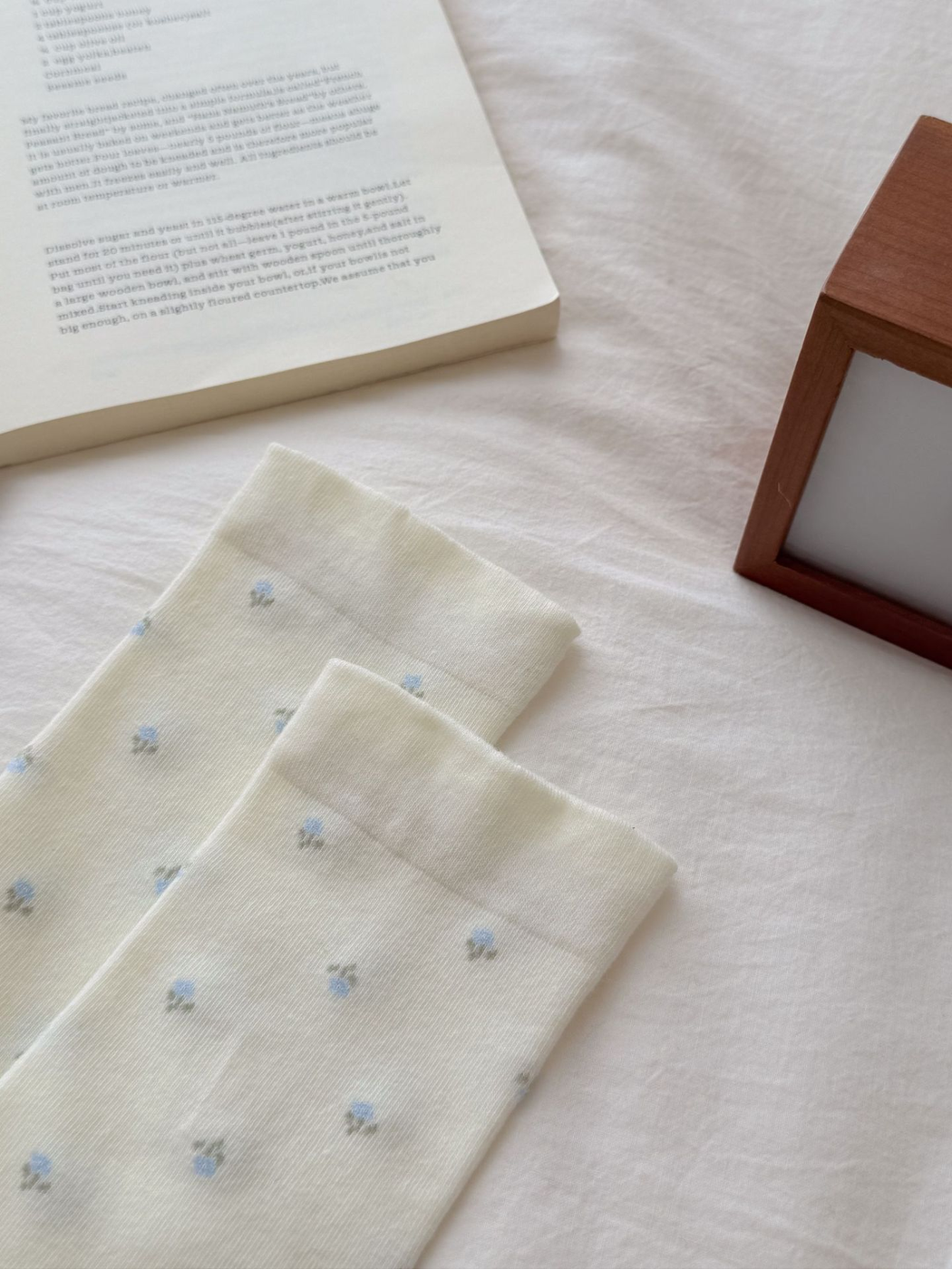 Close-up of the Ivory sock cuffs and light blue floral pattern