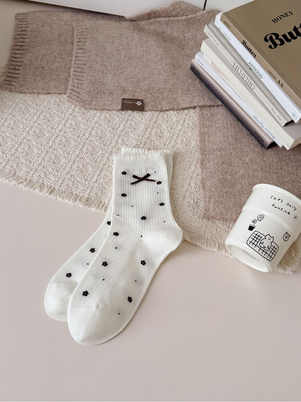 Ivory ribbed crew socks with floral dots, ruffled cuffs and bow accents