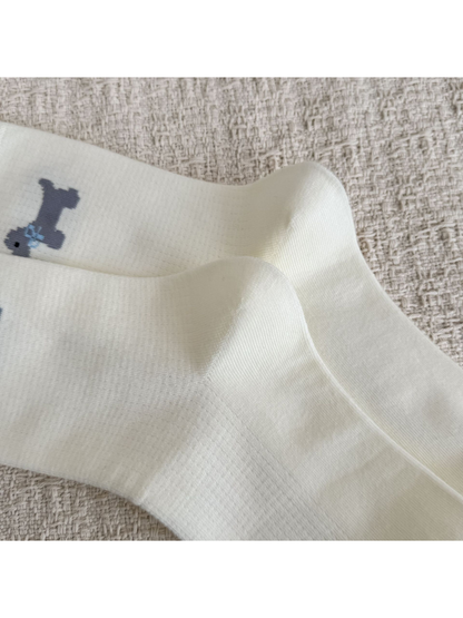 Close-up of the shaped heels and fine knit texture on ivory socks
