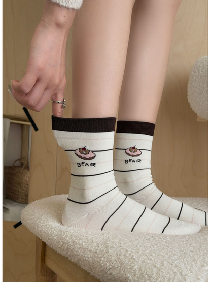 Striped Bear ivory crew socks worn together, close side view
