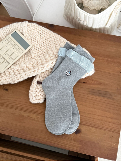 Ruffle Cuff heather gray crew socks with light blue dotted ruffle and embroidered motif