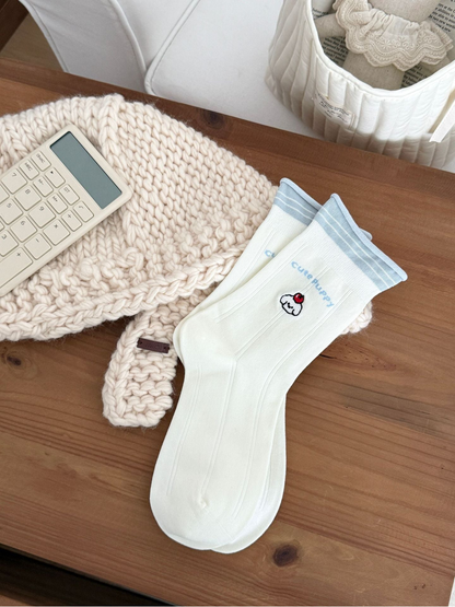 Rolled Cuff ivory crew socks with pale blue striped edge and embroidered character motif