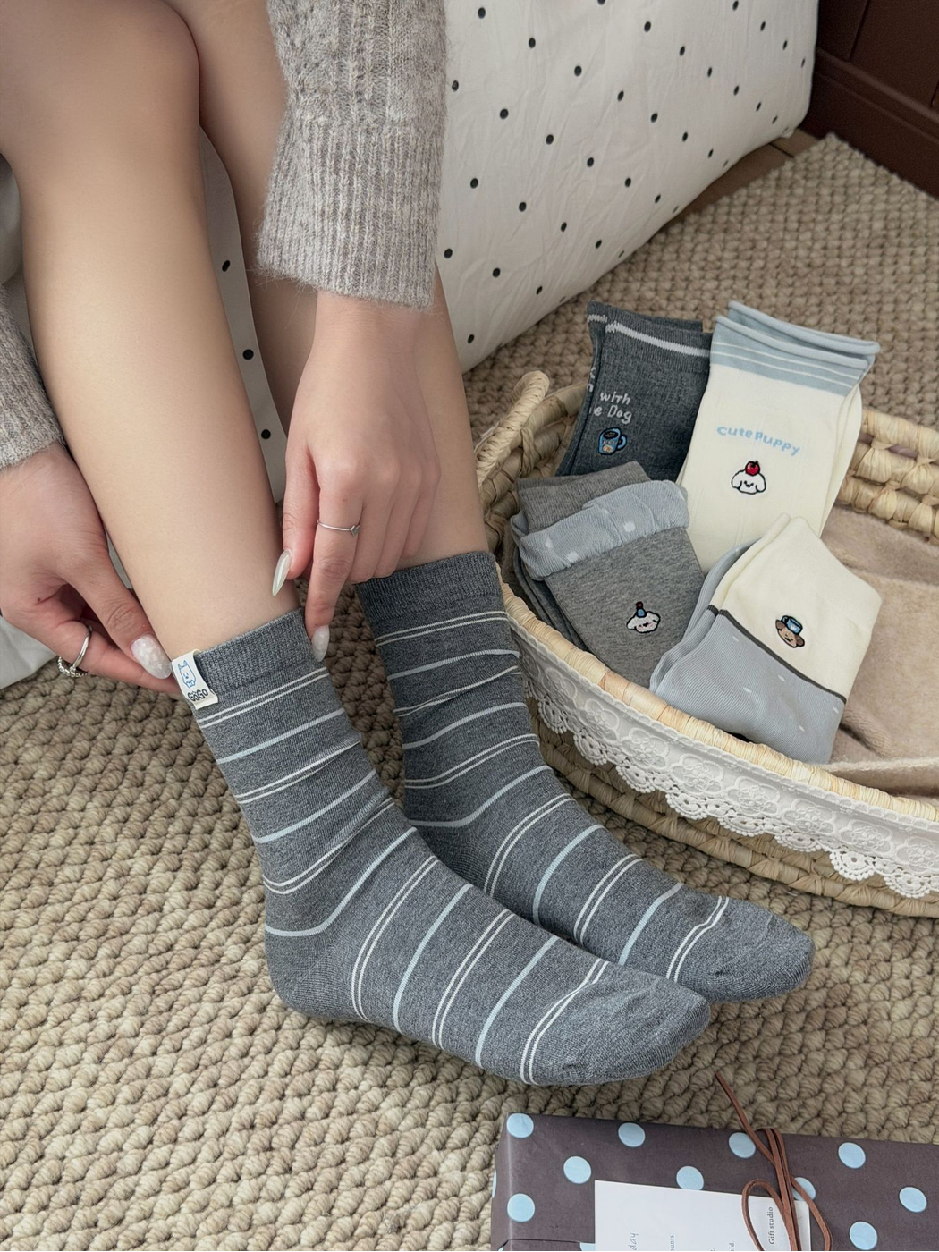 Stripes dark gray crew socks worn beside a basket of folded sock styles