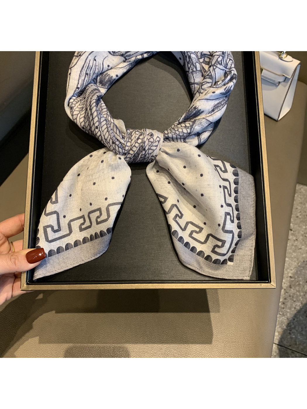Close-up of the scarf knot, dotted ends and geometric border