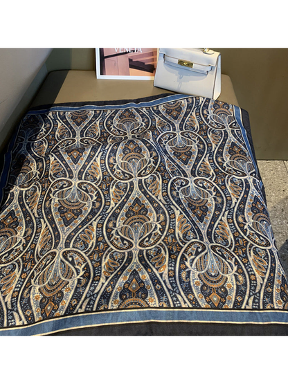 Navy paisley square scarf displayed flat with an ornamental pattern and striped border