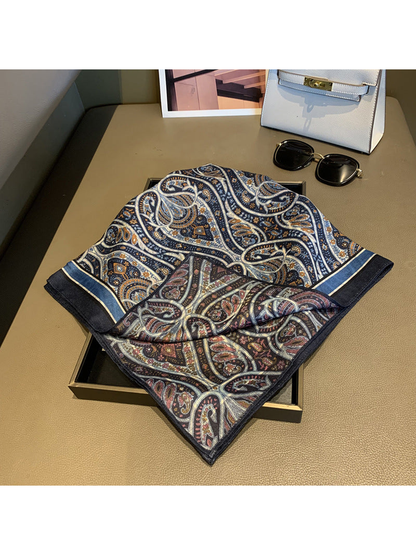 Navy and burgundy paisley square scarf displayed to reveal both patterned sides