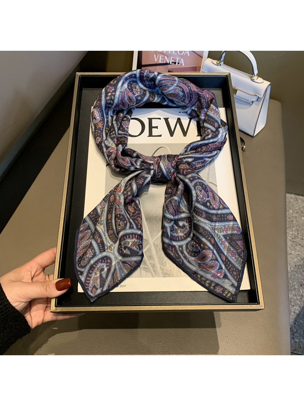 Burgundy and navy side of the paisley square scarf tied in a loop