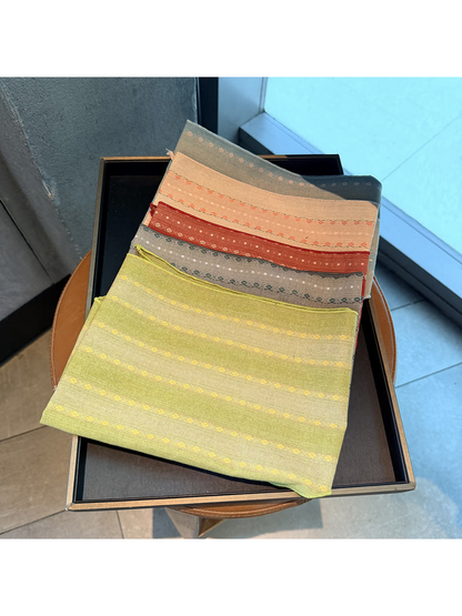 Yellow, gray, red, blush and light blue striped scarves displayed together