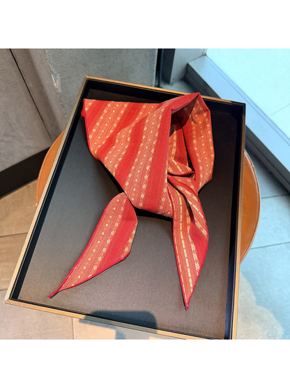 Red striped scarf tied on a display tray