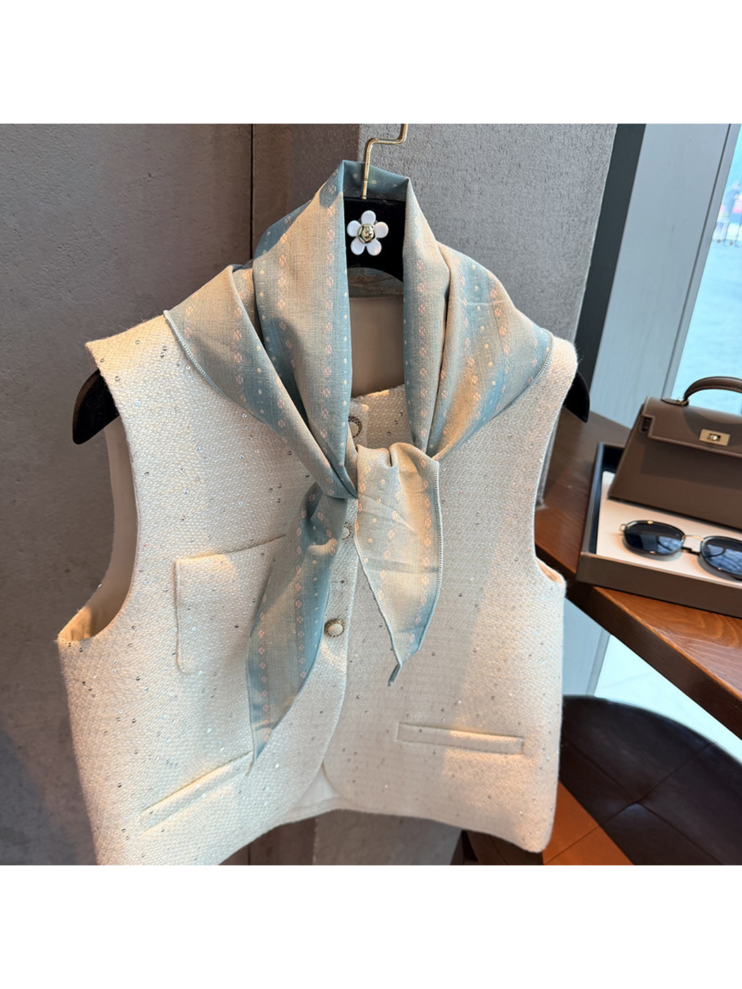 Light Blue striped scarf tied at the neck over a white vest