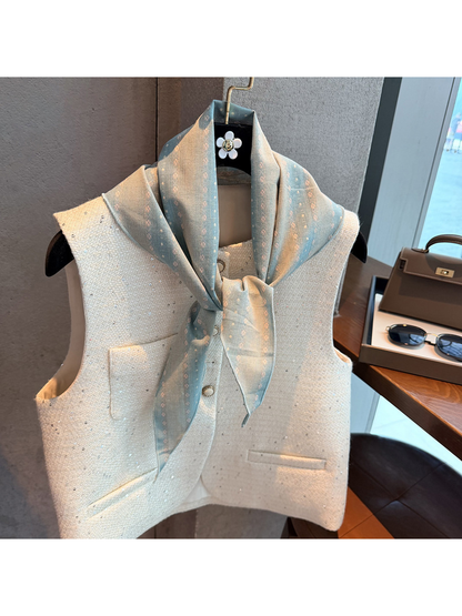 Light Blue striped scarf tied at the neck over a white vest