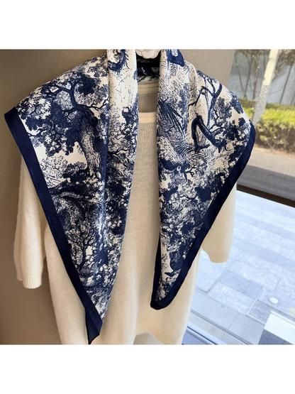 Detailed view of the navy woodland landscape print on the ivory scarf