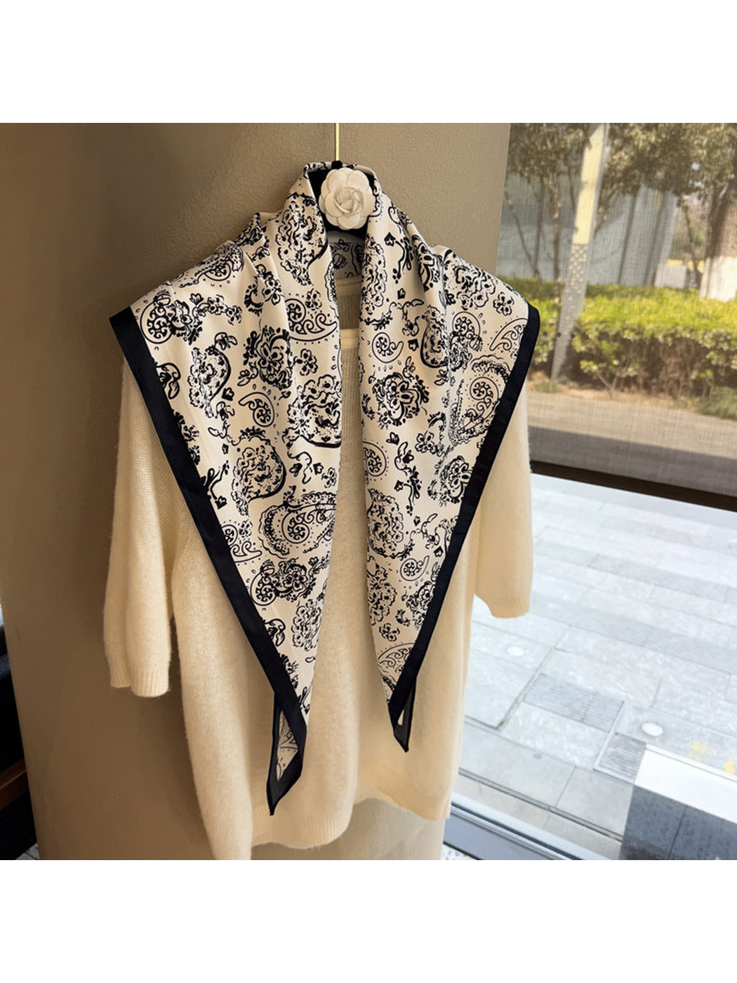 White paisley triangle scarf with dark border, full draped view